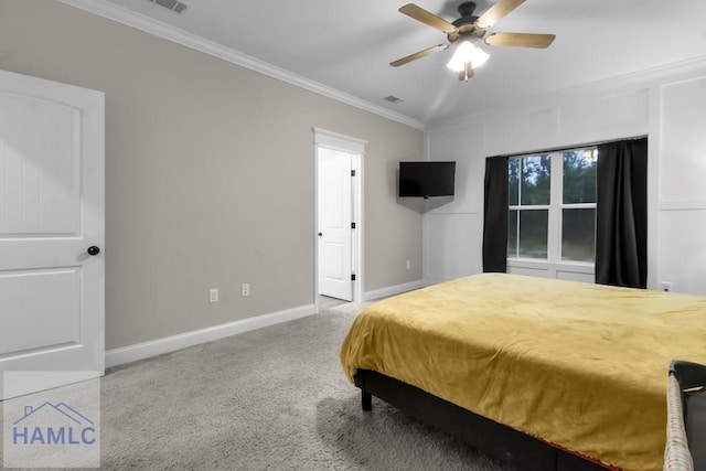 carpeted bedroom featuring crown molding and ceiling fan