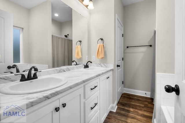 bathroom with vanity, wood-type flooring, and plus walk in shower