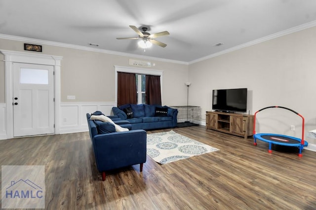 living room with ceiling fan, ornamental molding, and wood-type flooring