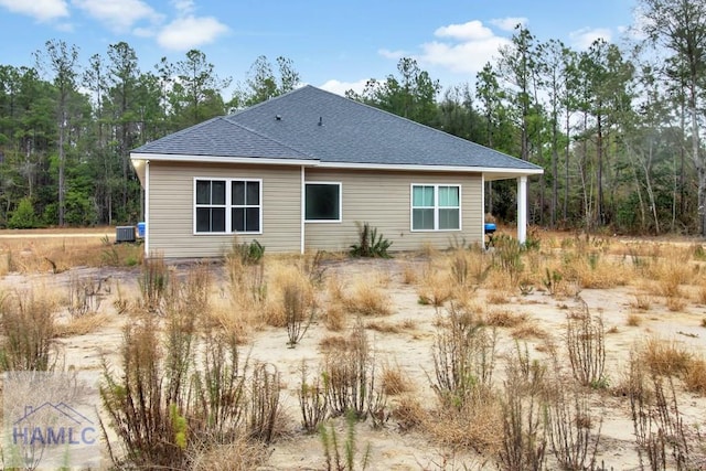 rear view of house featuring central AC