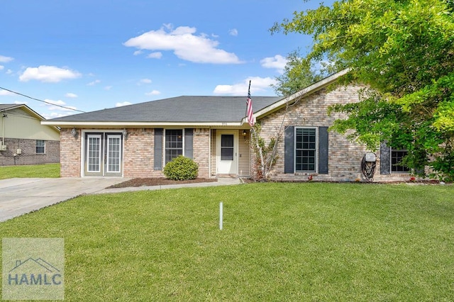 single story home with a front lawn and brick siding
