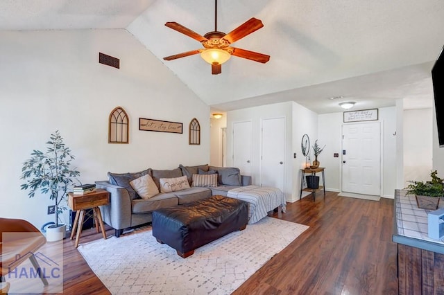 living area featuring visible vents, ceiling fan, dark wood-style floors, and high vaulted ceiling