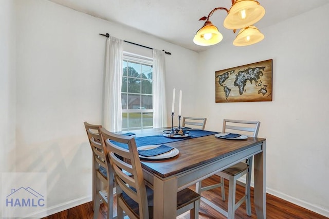 dining space featuring baseboards and wood finished floors