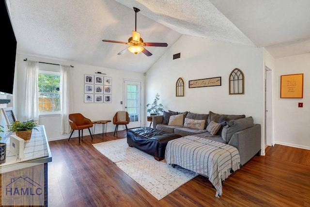 living room featuring a ceiling fan, a textured ceiling, visible vents, and wood finished floors