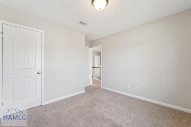 7 Summerhill Dr, Ludowici, GA 31316 - unfurnished bedroom featuring carpet floors, a textured ceiling, baseboards, and visible vents