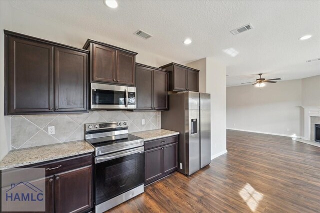 7 Summerhill Dr, Ludowici, GA 31316 - kitchen with visible vents, dark brown cabinetry, open floor plan, a ceiling fan, and stainless steel appliances