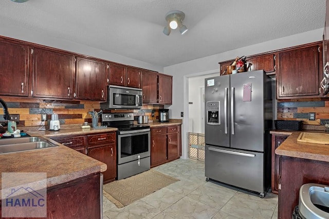 kitchen featuring stainless steel appliances, tasteful backsplash, and sink