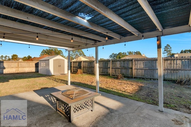 view of patio with an outdoor fire pit and a shed