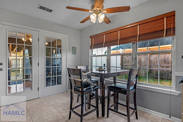 dining room featuring a textured ceiling and ceiling fan