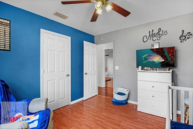 bedroom featuring ceiling fan, a textured ceiling, and hardwood / wood-style flooring