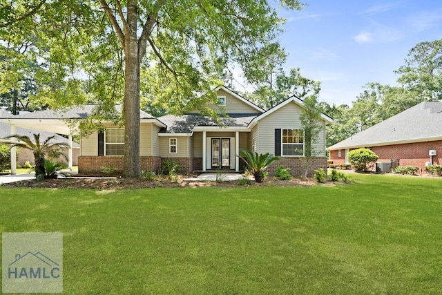 78 Heron View Ct, Richmond Hill, GA 31324 - view of front of house featuring brick siding, a front yard, central air condition unit, and french doors