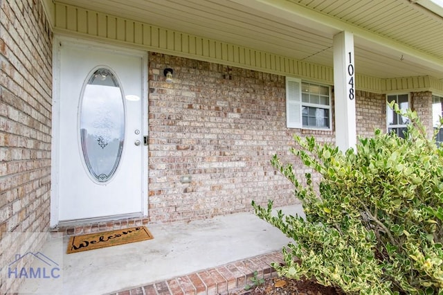 1048 Barley Dr, Hinesville, GA 31313 - view of exterior entry with brick siding and a porch
