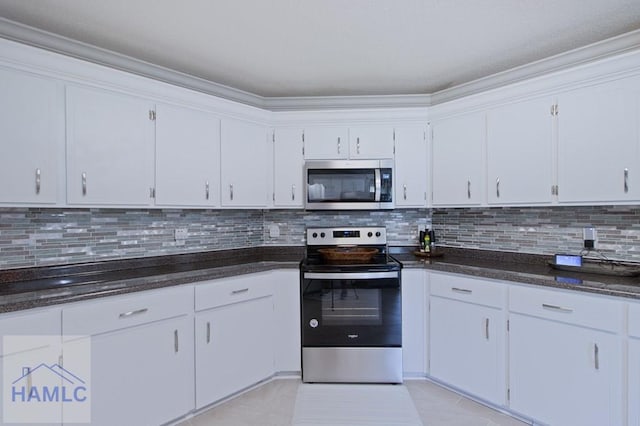 1048 Barley Dr, Hinesville, GA 31313 - kitchen featuring appliances with stainless steel finishes, backsplash, light tile patterned floors, ornamental molding, and dark stone counters