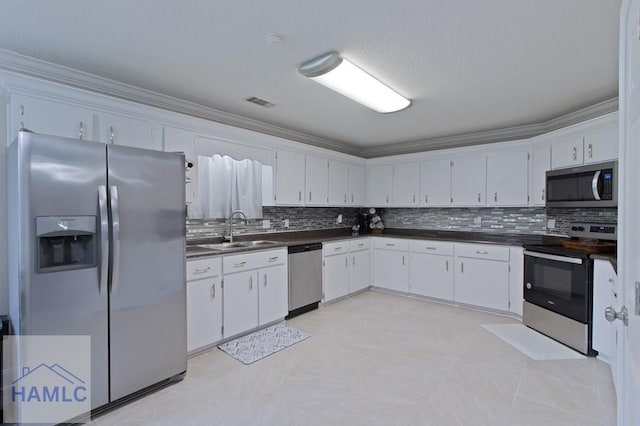 1048 Barley Dr, Hinesville, GA 31313 - kitchen with appliances with stainless steel finishes, a sink, dark countertops, decorative backsplash, and crown molding
