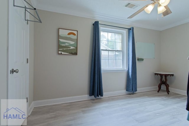1048 Barley Dr, Hinesville, GA 31313 - spare room with crown molding, wood finished floors, a ceiling fan, and baseboards