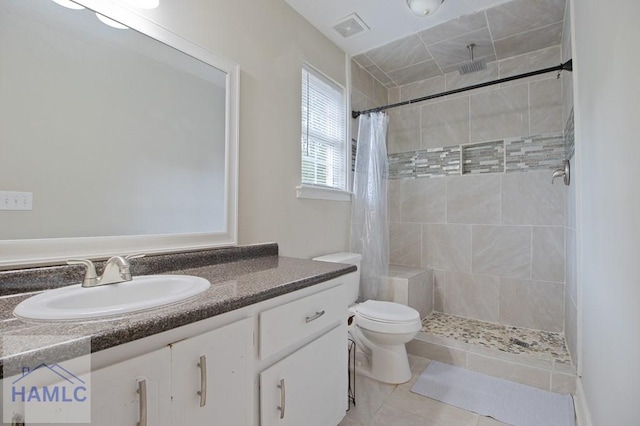 1048 Barley Dr, Hinesville, GA 31313 - full bathroom with tiled shower, tile patterned floors, vanity, and toilet