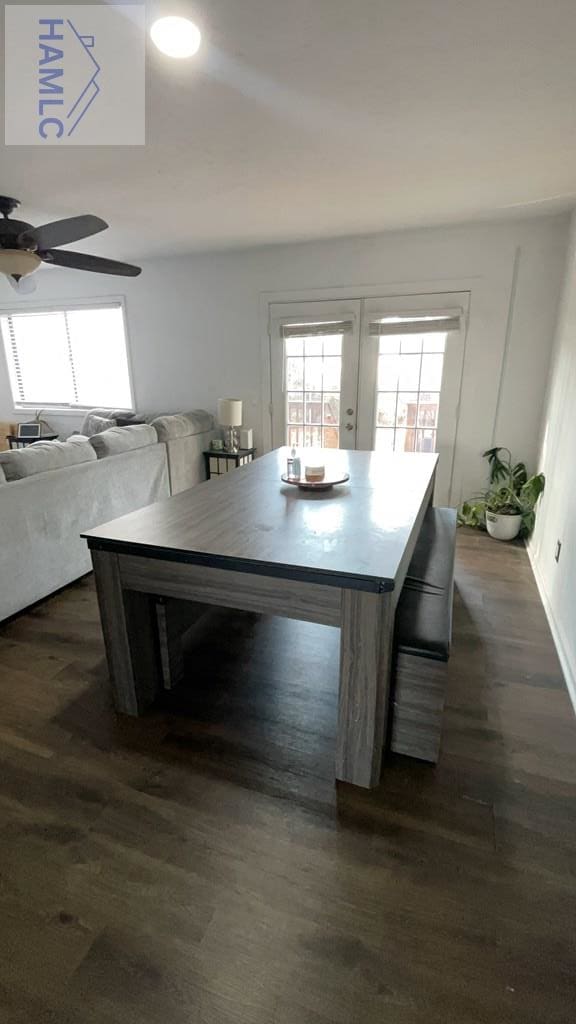 unfurnished dining area with dark wood finished floors and a ceiling fan