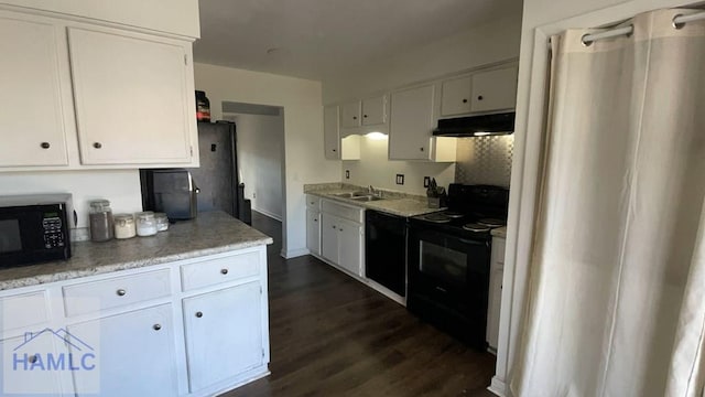 kitchen with black appliances, a sink, white cabinetry, and under cabinet range hood