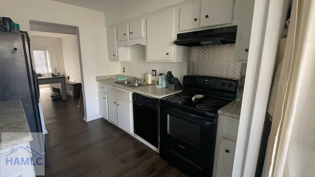 kitchen featuring under cabinet range hood, a sink, white cabinetry, light countertops, and black appliances