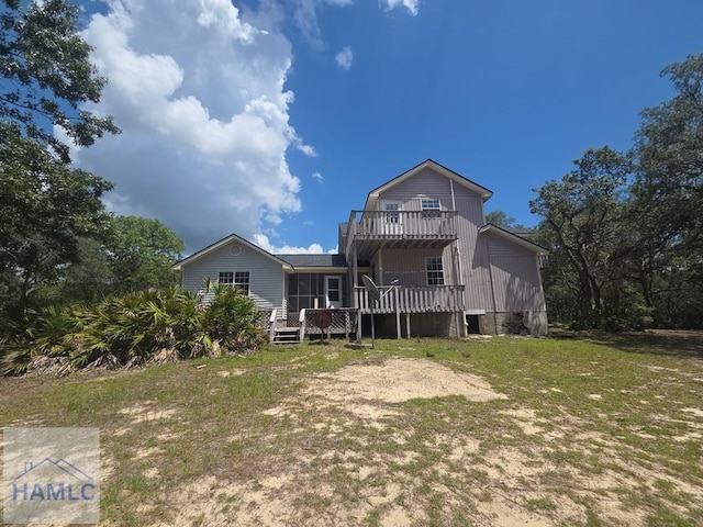 5927 Yellow Bluff Rd, Blackshear, GA 31516 - back of house with a wooden deck and a lawn