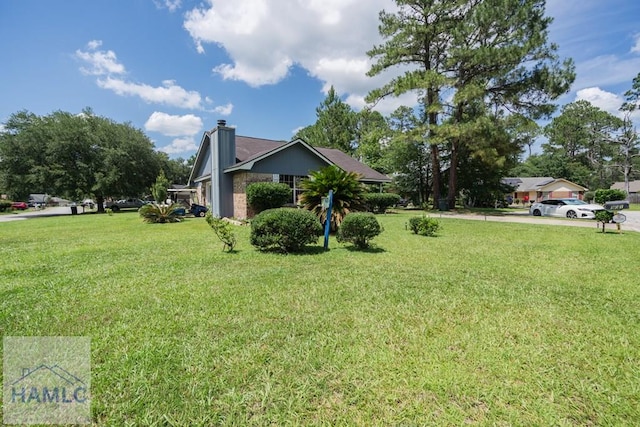 901 Pintail Ct, Hinesville, GA 31313 - view of side of property featuring a yard and a chimney