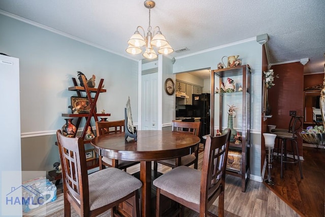 901 Pintail Ct, Hinesville, GA 31313 - dining room featuring a chandelier, crown molding, and wood finished floors
