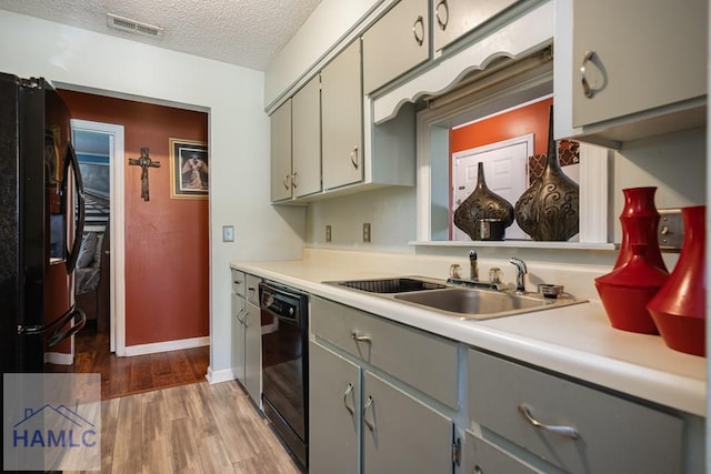 901 Pintail Ct, Hinesville, GA 31313 - kitchen featuring gray cabinets, black appliances, light wood-type flooring, a textured ceiling, and light countertops