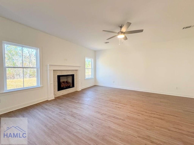 unfurnished living room with hardwood / wood-style flooring and ceiling fan