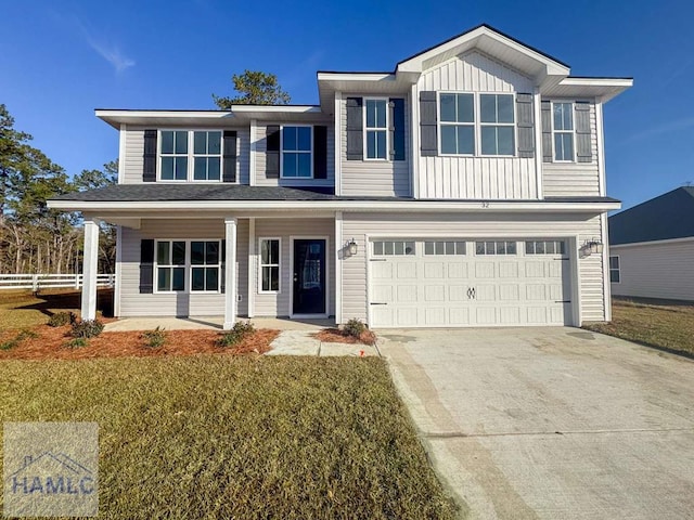 view of front of property featuring a front yard and a garage