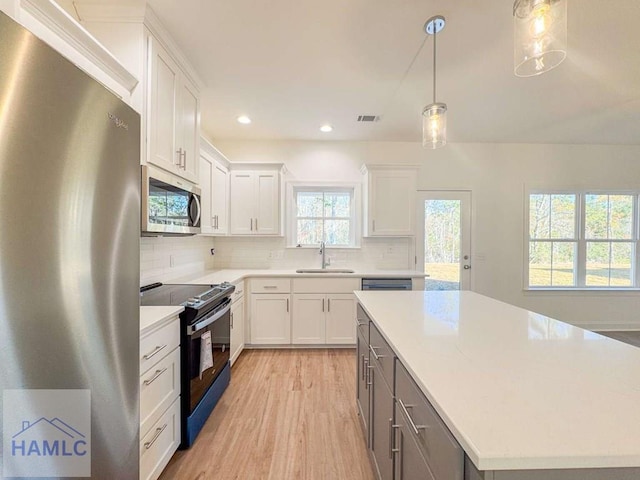 kitchen with sink, white cabinets, and appliances with stainless steel finishes