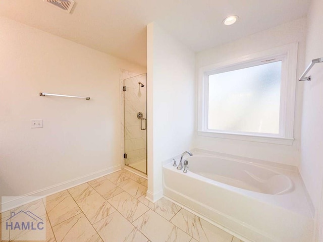 bathroom featuring separate shower and tub