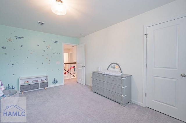 bedroom with light carpet and baseboards
