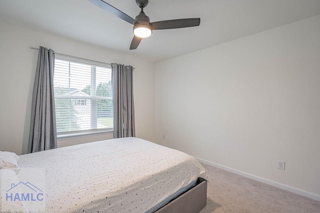 carpeted bedroom featuring baseboards and ceiling fan