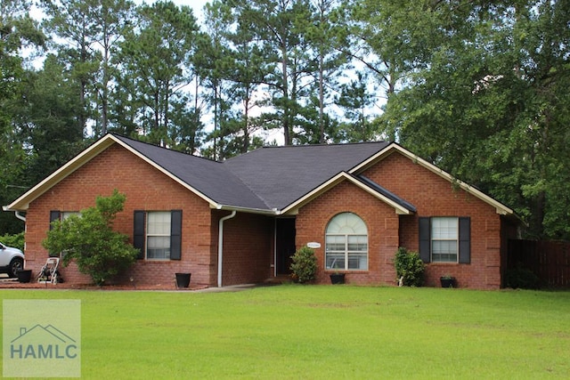 128 Youngblood Dr, Midway, GA 31320 - ranch-style home with brick siding and a front lawn