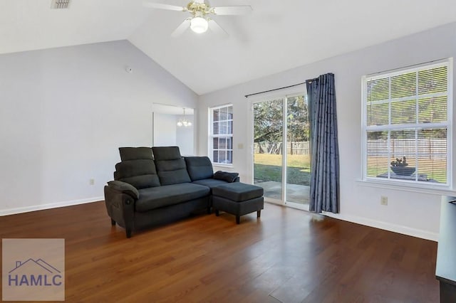 living room featuring vaulted ceiling, dark hardwood / wood-style floors, and ceiling fan with notable chandelier