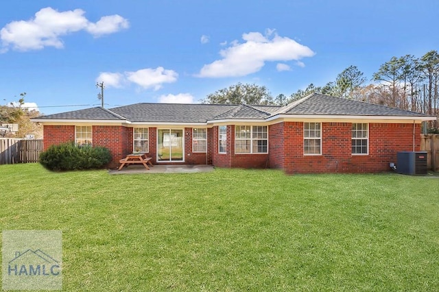 rear view of property featuring a patio area, central AC unit, and a lawn