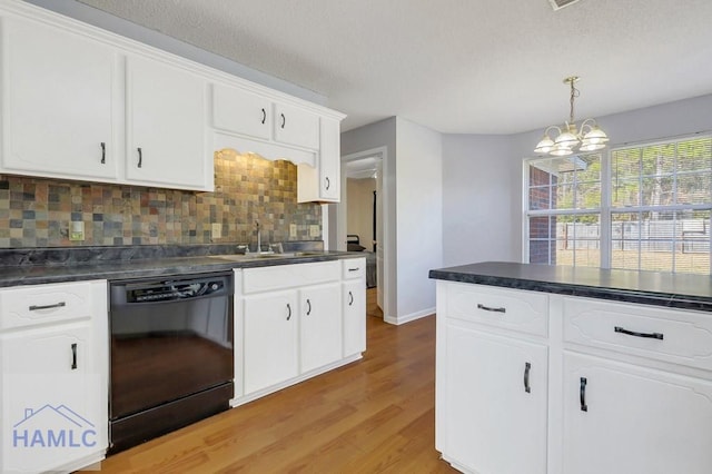 kitchen featuring sink, white cabinetry, tasteful backsplash, hanging light fixtures, and dishwasher