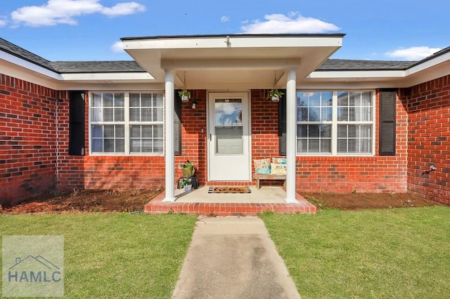 property entrance with a lawn