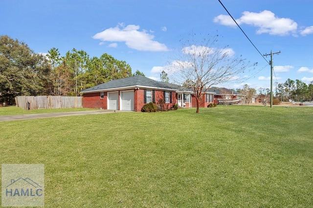 single story home with a garage and a front lawn