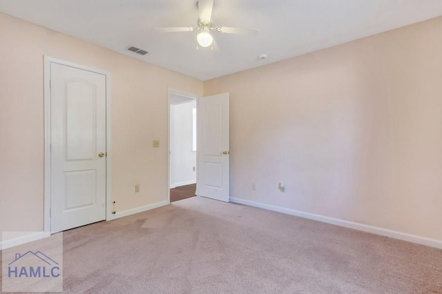 carpeted empty room with ceiling fan