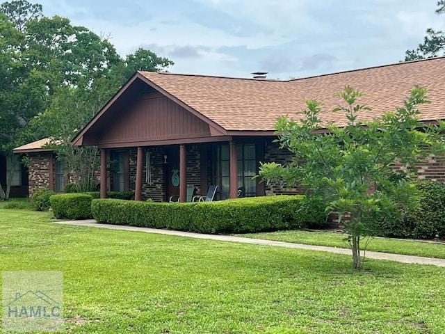 224 Bacon St, Jesup, GA 31545 - view of front facade featuring a shingled roof and a front lawn