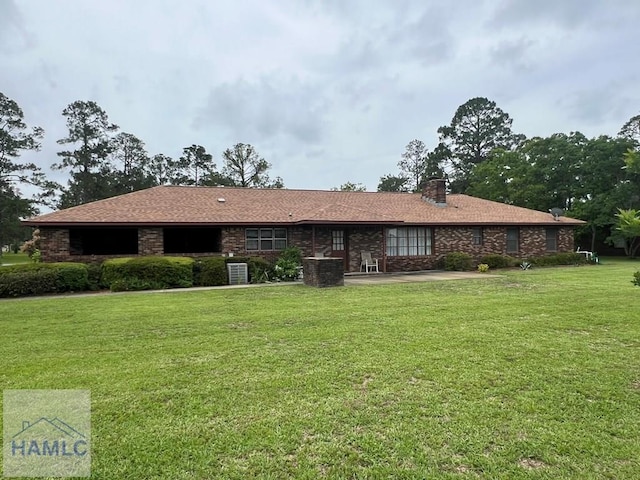 224 Bacon St, Jesup, GA 31545 - ranch-style home featuring a front lawn, a chimney, and a patio area