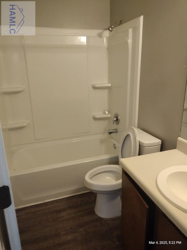 full bathroom featuring bathtub / shower combination, vanity, toilet, and wood finished floors