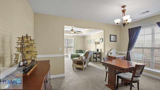 carpeted office featuring visible vents, baseboards, a raised ceiling, and ceiling fan with notable chandelier