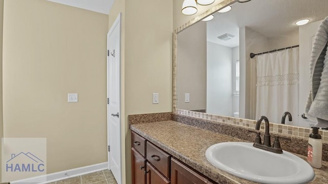 bathroom featuring tile patterned floors, visible vents, a shower with curtain, baseboards, and vanity