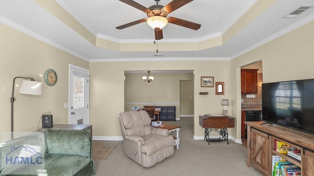 living room featuring visible vents, ceiling fan with notable chandelier, light colored carpet, and a raised ceiling