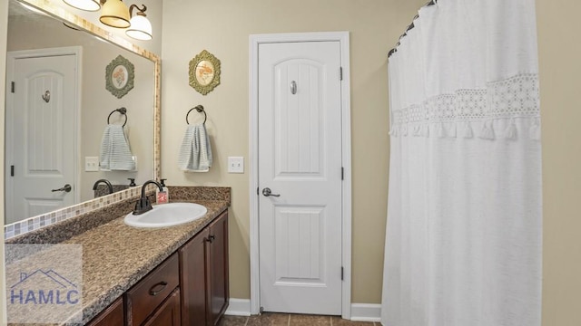 full bathroom featuring vanity and baseboards