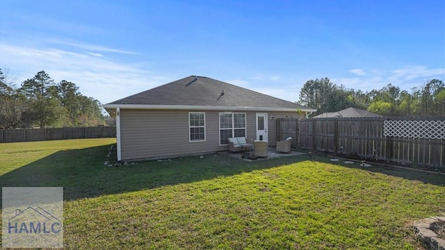 back of property featuring a fenced backyard and a lawn