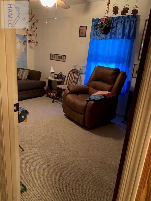 living room featuring carpet flooring and ceiling fan