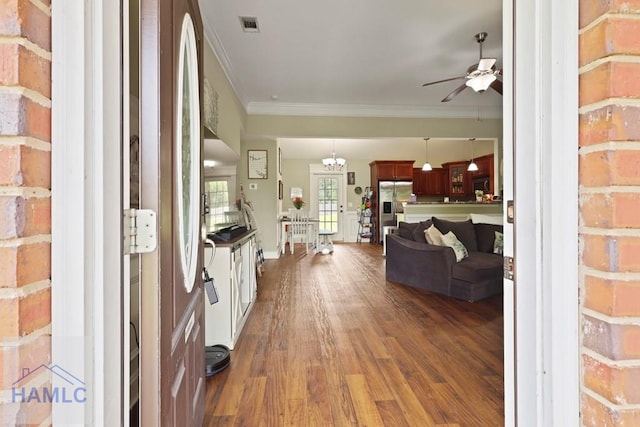 308 Mancey Garrason Loop NE, Ludowici, GA 31316 - entrance foyer featuring ceiling fan, crown molding, and dark wood-style flooring